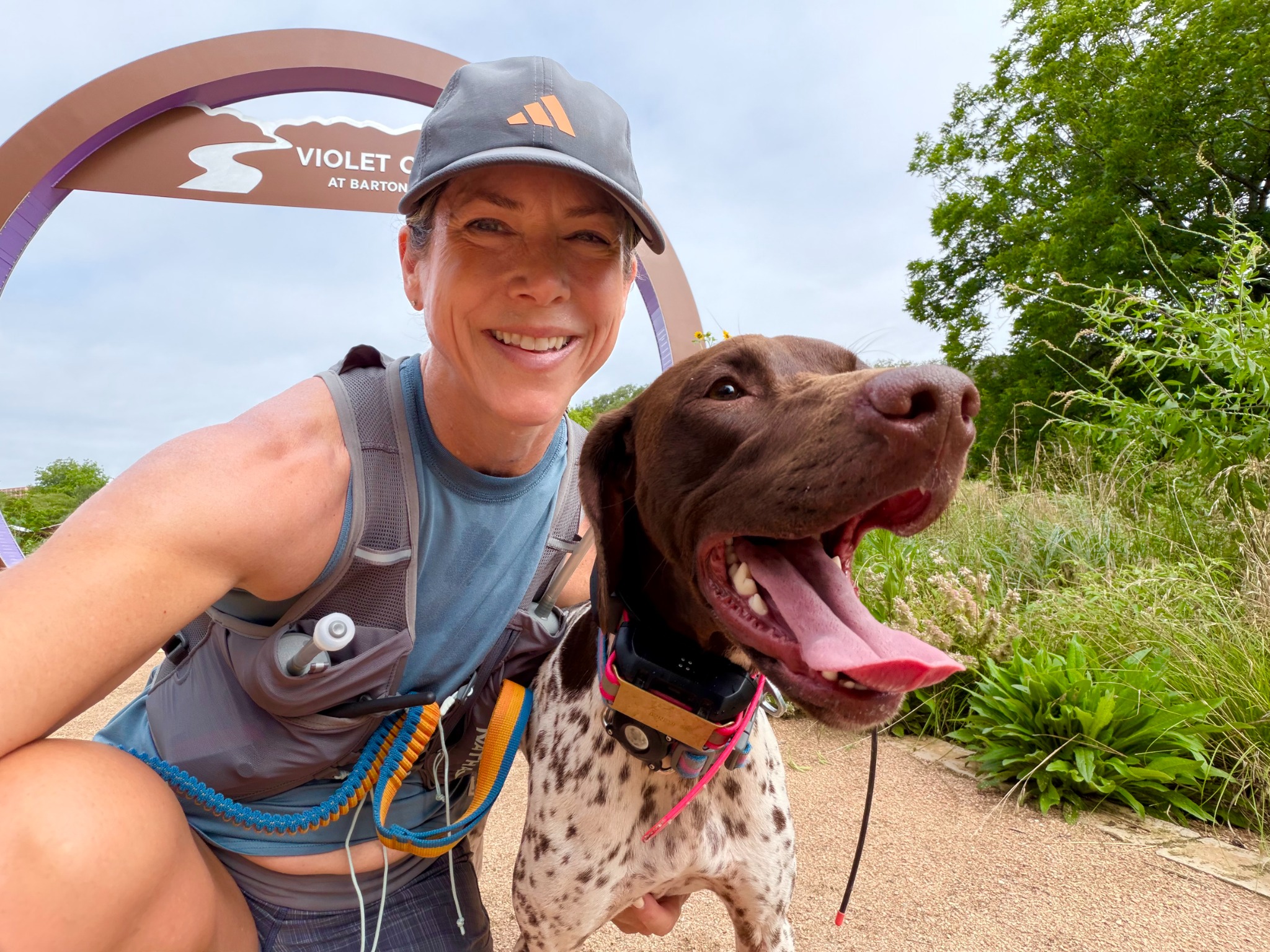 Ali hiking with her dog on the Violet Crown Trail
